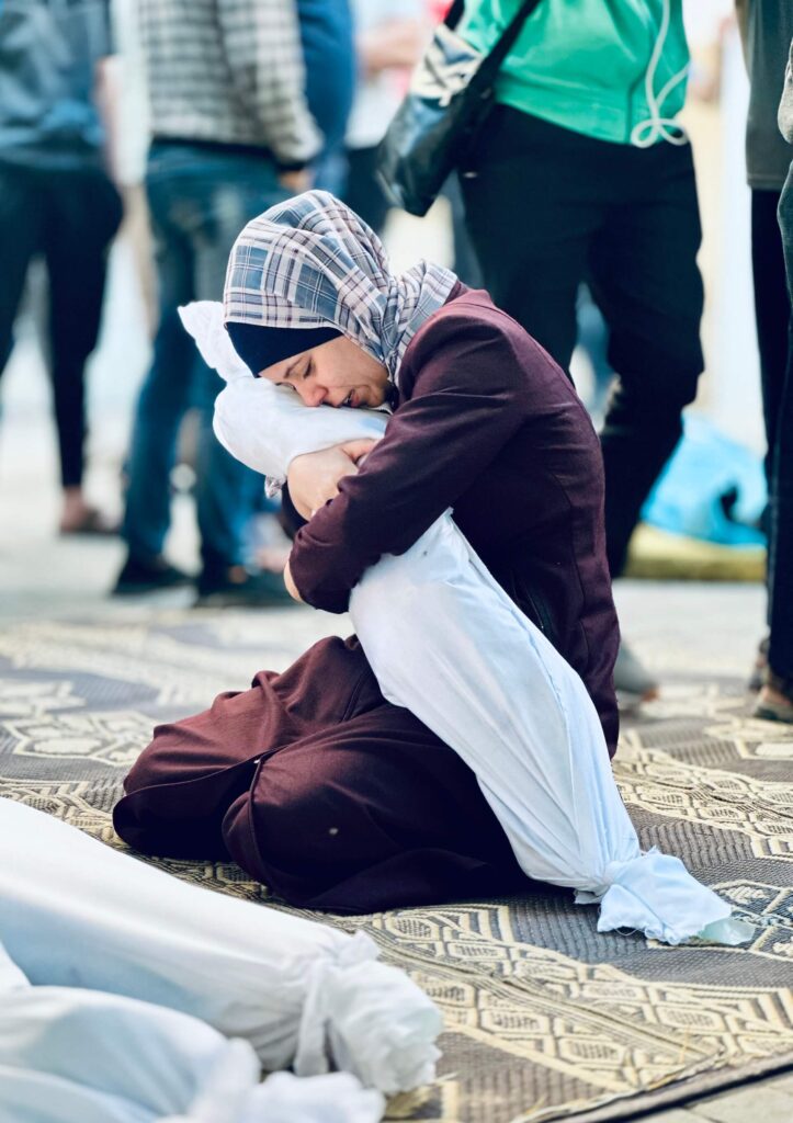 Sumaya Al-Atrash, a Palestinian Woman from Rafah, bids farewell to her niece who was martyred along with her family during the bombing of their home.