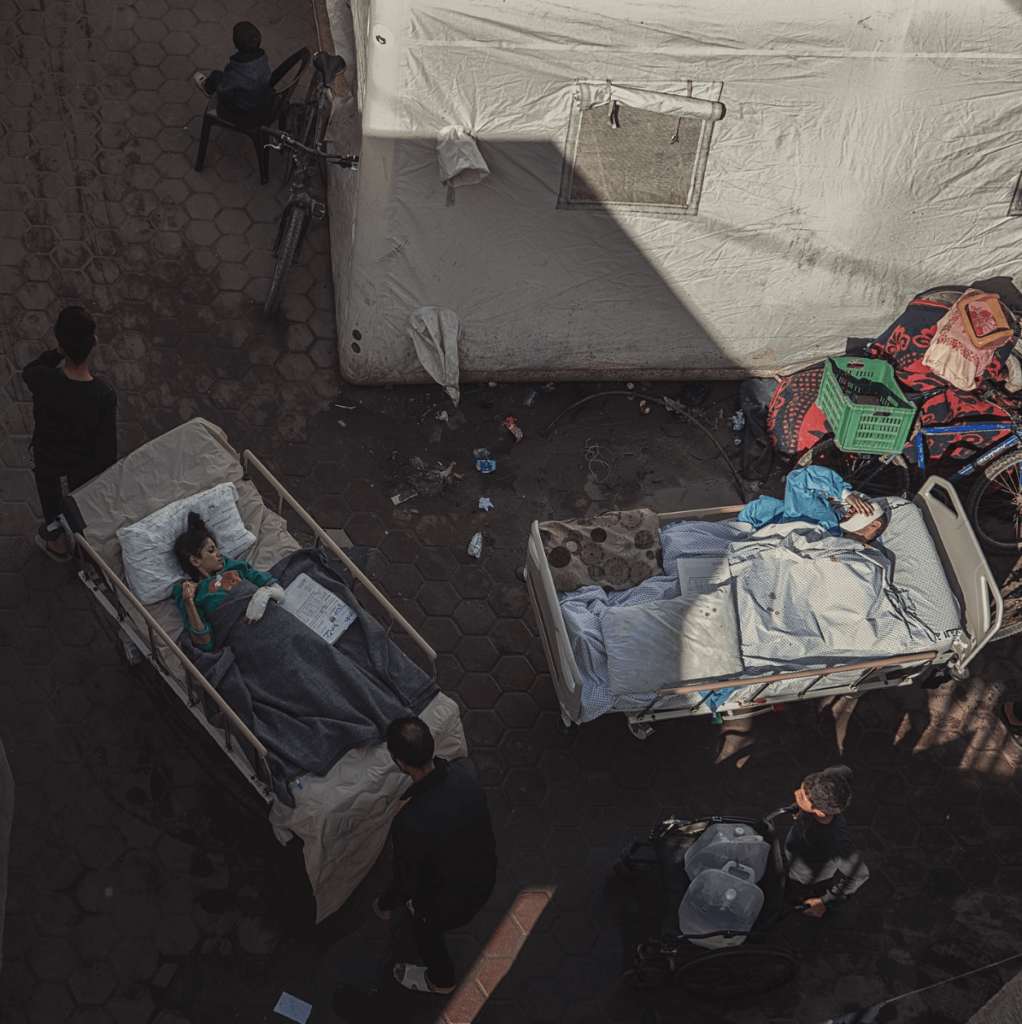 Gaza wounded are splitting the sun light ! An injured Palestinian in the hospital bed trying to get some sunlight after the little injured girl finished from exposing to the sun light