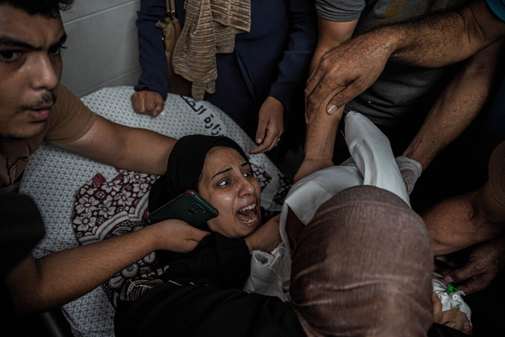 A Palestinian woman bids farewell to her childdaughter who was martyred at dawn today after bombing their house, resulting in the injury of the mother and the loss of her child.