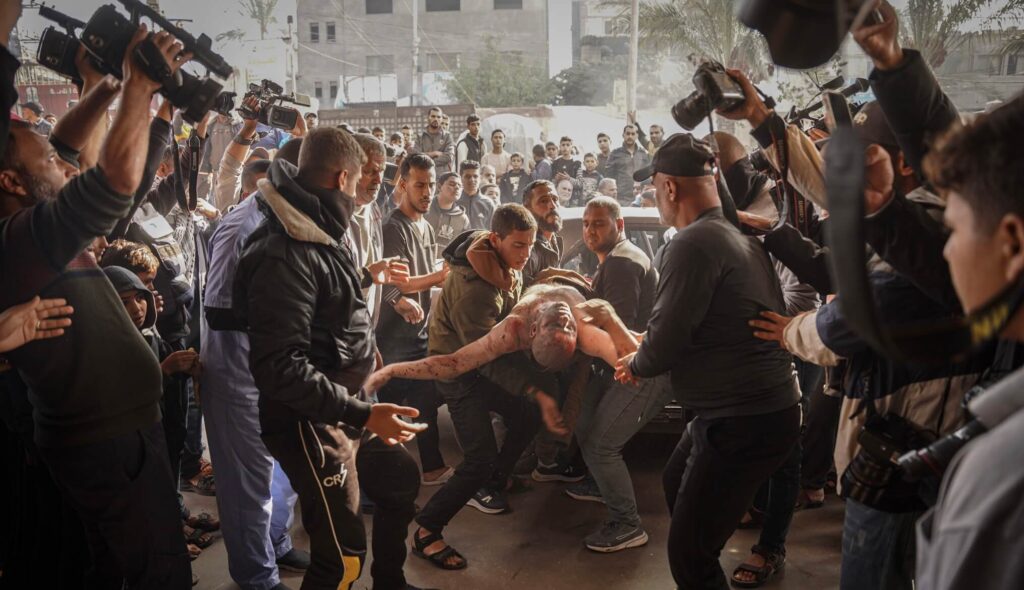 Palestinians carry an injured man following the Israeli bombing on Khan Yunis, south of the Gaza Strip.