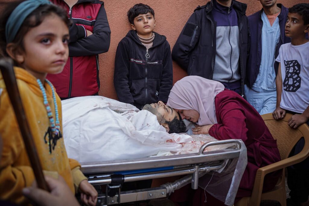 A Palestinian woman cries over the head of her husband, who was martyred as a result of the Israeli bombing on Khan Yunis, south of the Gaza Strip.